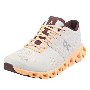 On Running Cream and Peach Athletic Shoes